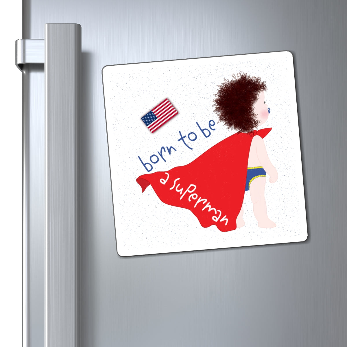 Fridge magnet with a child in a superhero costume and 'born to be a superman' text on a silver refrigerator.
