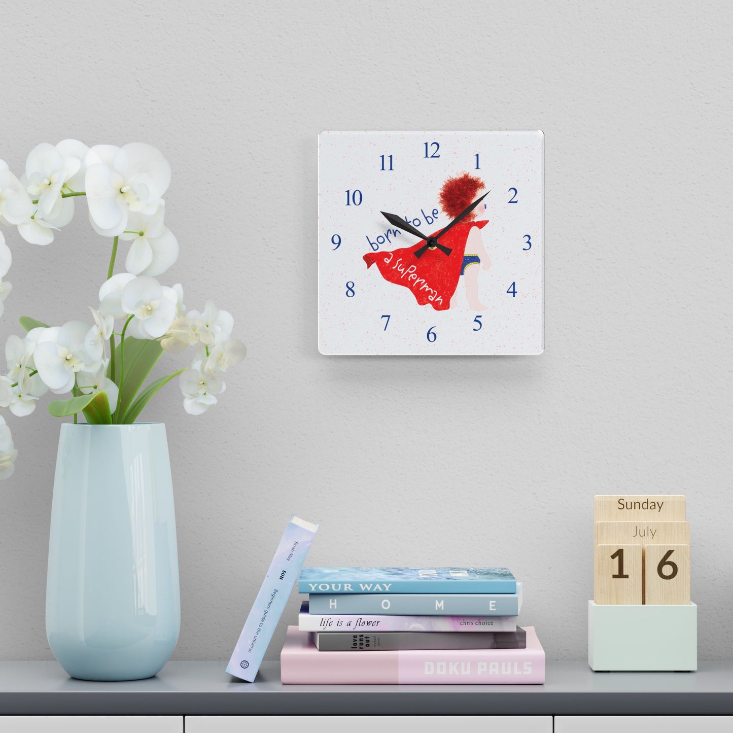 Funny redhead superhero nursery wall clock above books and flowers – acrylic baby shower gift from Kidlic USA