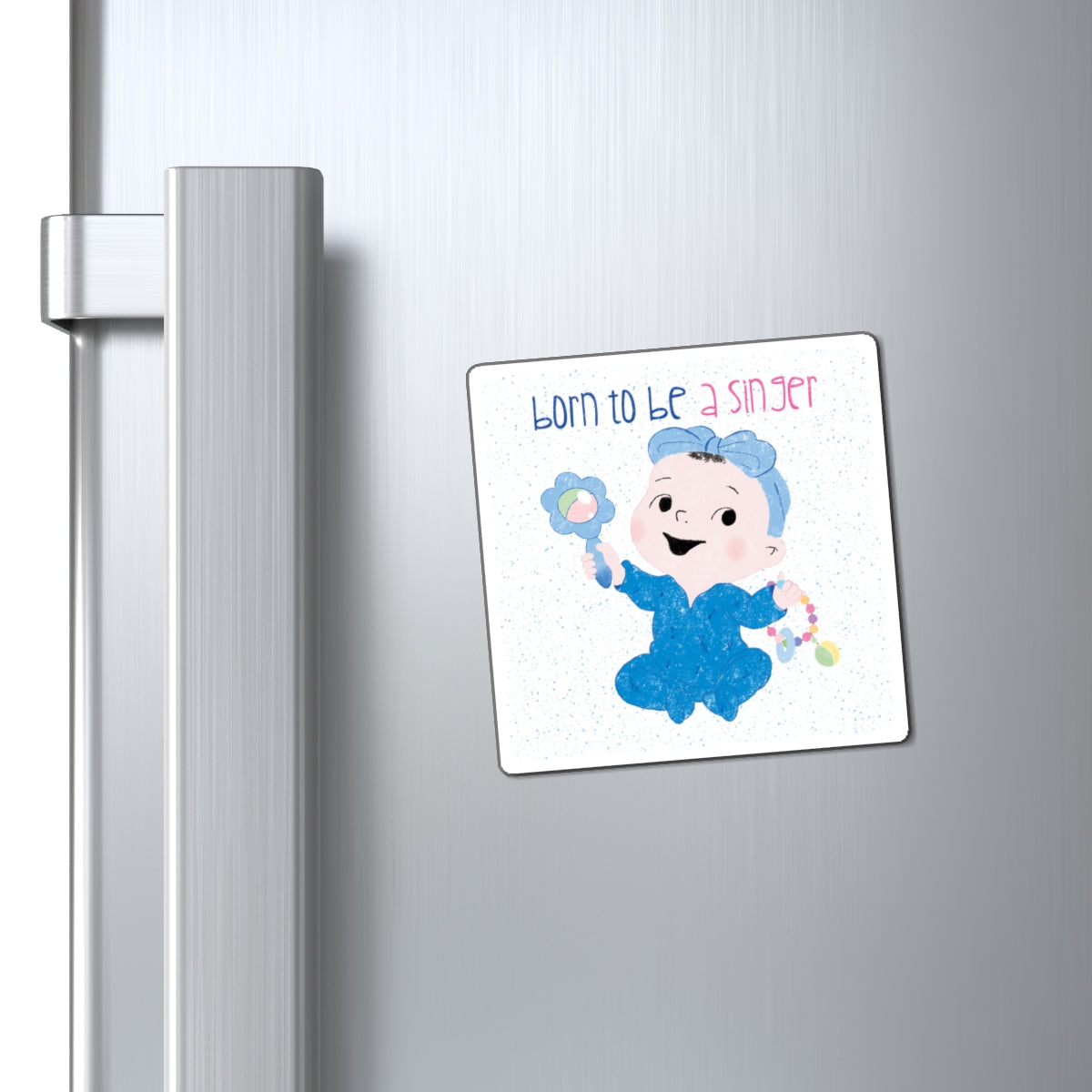 Playful nursery fridge magnet (3”x3” size) featuring a cartoon baby girl holding a rattle, with the text "Born to be a singer”, close-up, kidlic