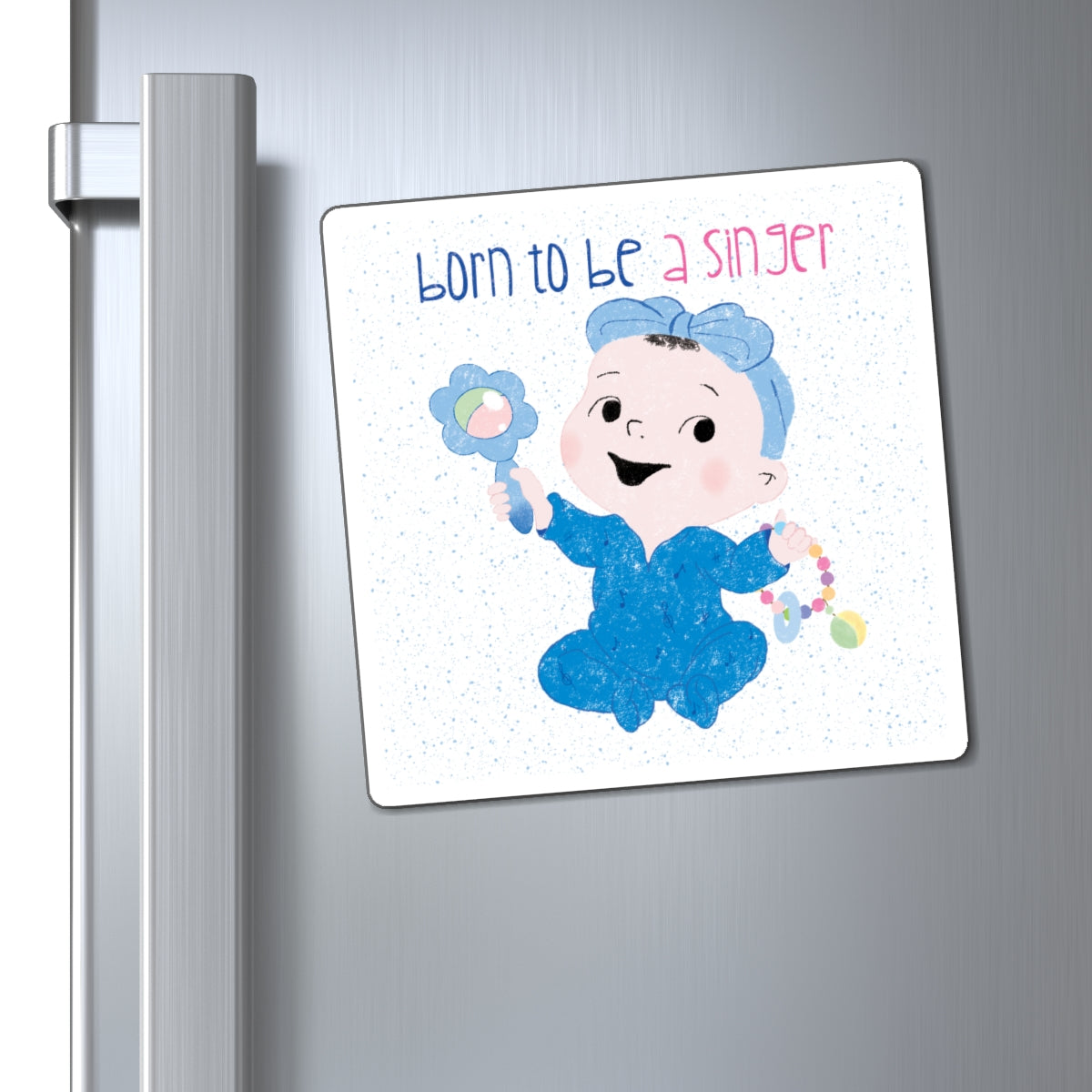 Playful nursery fridge magnet (6”x6” size) featuring a cartoon baby girl holding a rattle, with the text "Born to be a singer”, close-up, kidlic