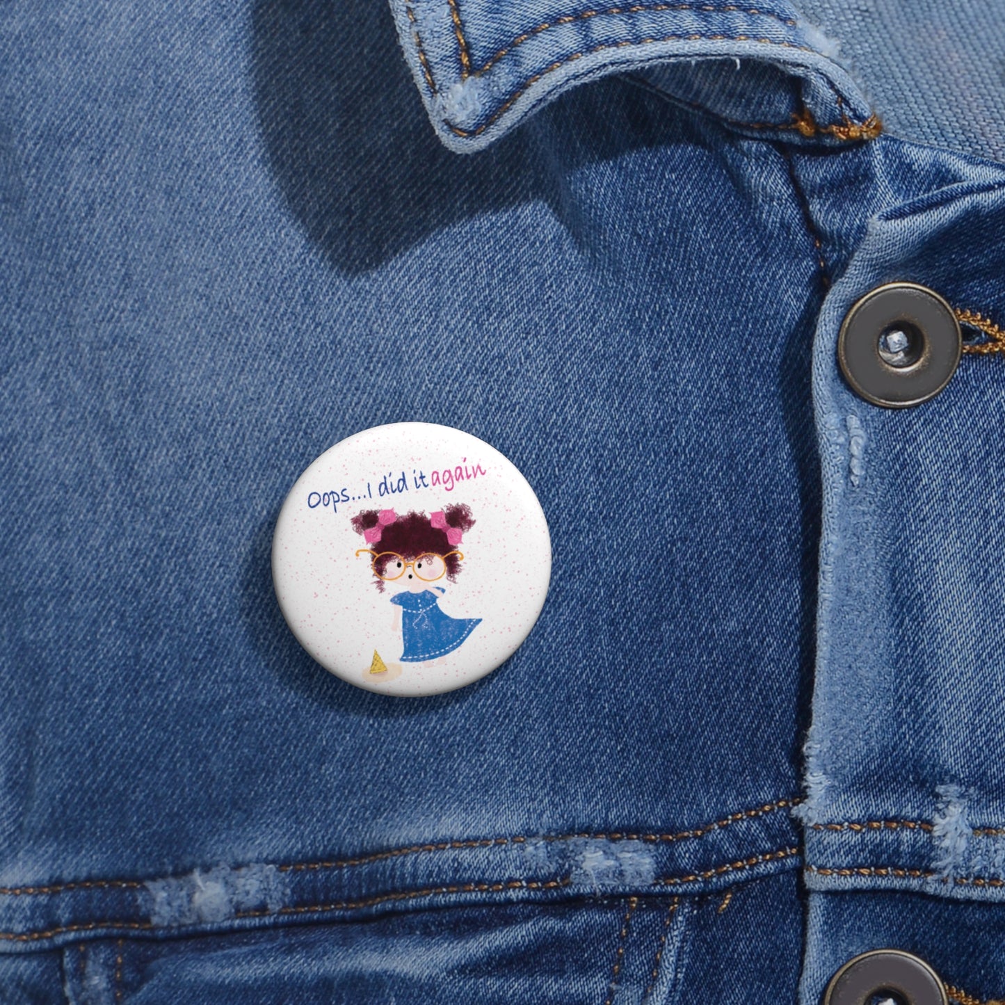 Hilarious nursery round pin button featuring a cartoon girl with curly hair, oversized glasses, and a blue dress, standing next to a fallen ice cream cone, with the text 'Oops... I did it againâ, size 1â, close-up, kidlic