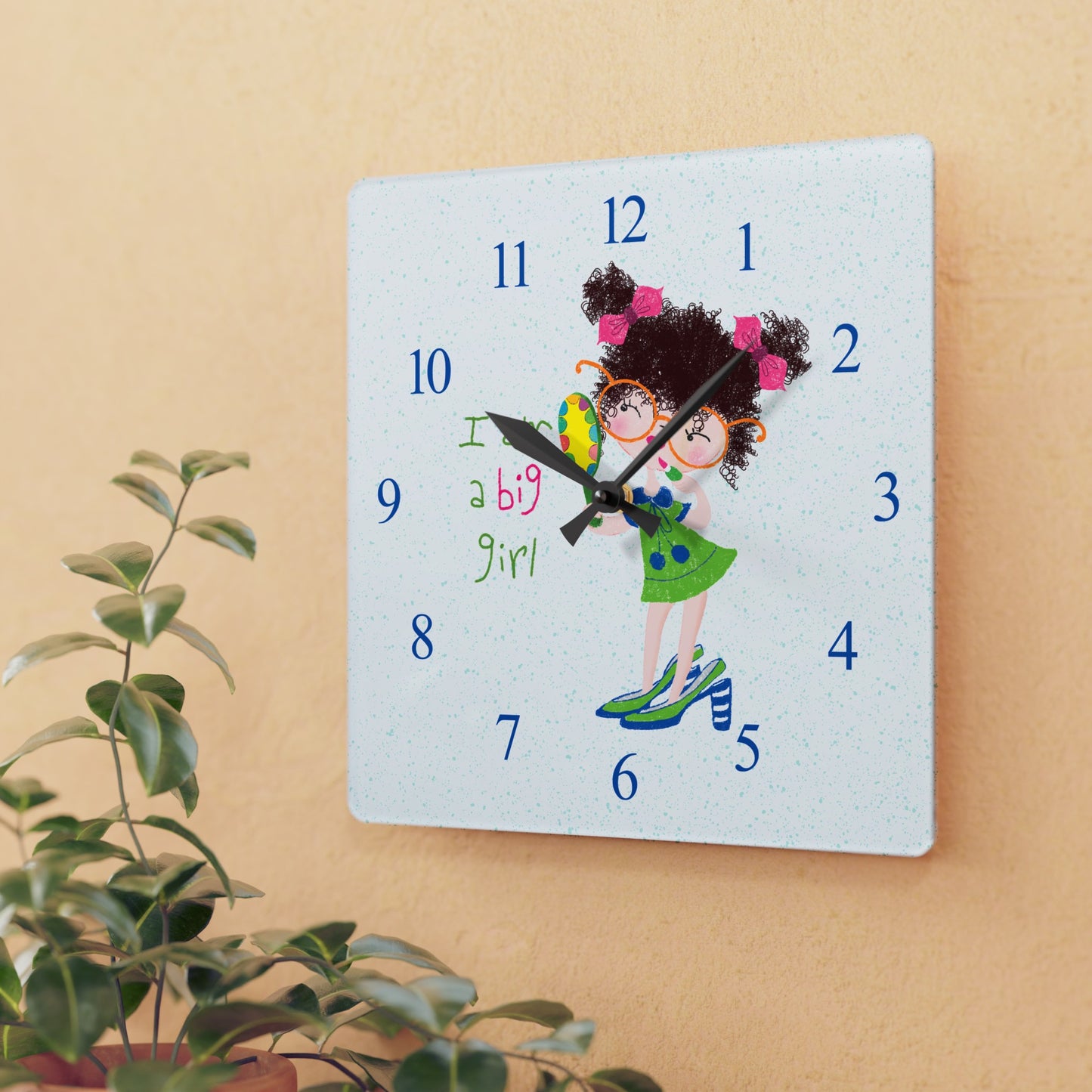 Humorous nursery acrylic wall clock featuring a cartoon girl with curly hair, oversized glasses, and a green dress, holding a mirror, with the text 'I am a big girl' alongside blue numbers on the clock face, size 10.75”x10.75” (square), close-up, kidlic