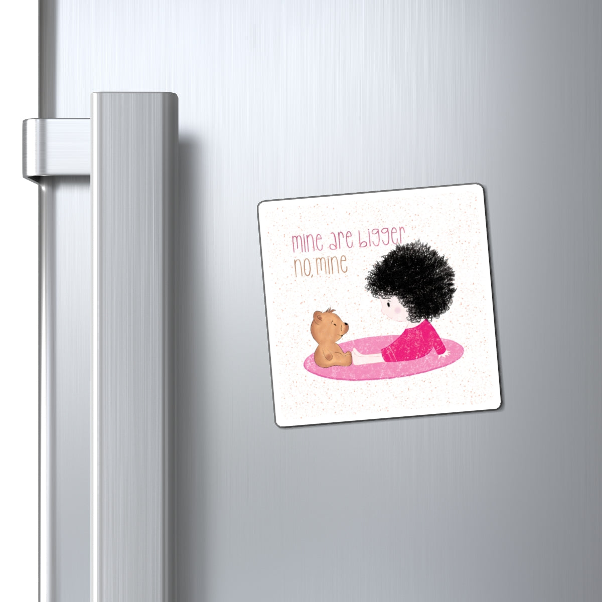 Sweet fridge magnet featuring a cartoon baby girl sitting on a pink mat, facing a brown stuffed teddy bear,  with the text 'mine are bigger, no, mine’, size 3”x3”, close-up, kidlic 