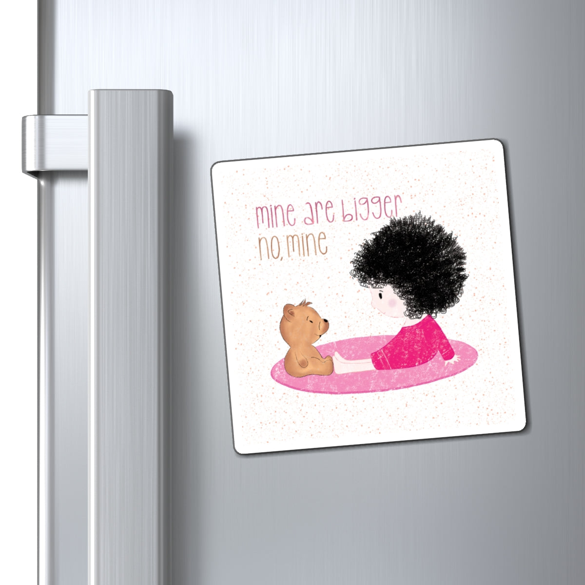 Sweet fridge magnet featuring a cartoon baby girl sitting on a pink mat, facing a brown stuffed teddy bear,  with the text 'mine are bigger, no, mine’, size 4”x4”, close-up, kidlic 