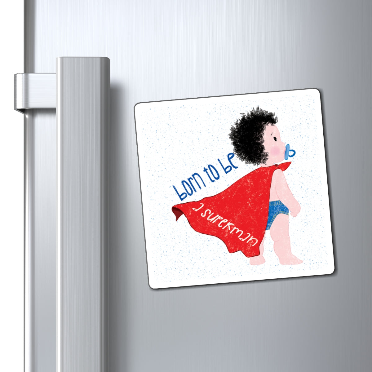 Playful (4”x4” size) fridge magnet featuring a cartoon baby with a pacifier, wearing a red cape, with the text 'Born to be a superman’, close-up, kidlic