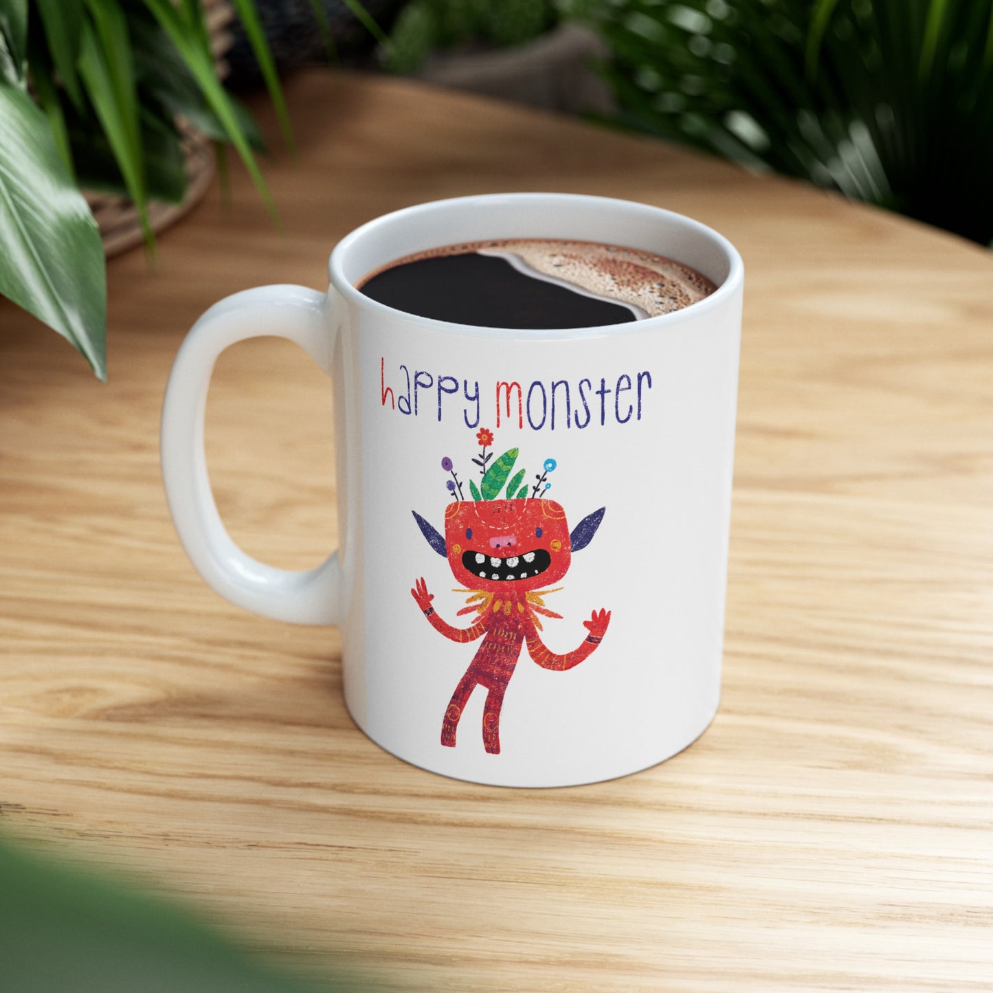 Playful coffee mug featuring a red happy monster bursting with excitement, and the text 'Happy Monster’ on a coffee table, 11 oz, kidlic