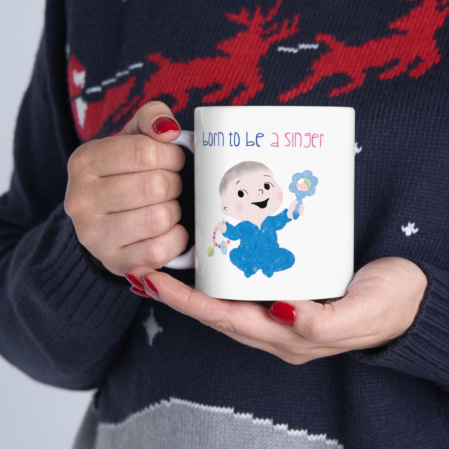 Playful nursery coffee mug featuring a cartoon baby boy holding a rattle, with the text "Born to be a singer”, size: 11 oz, close-up, kidlic 