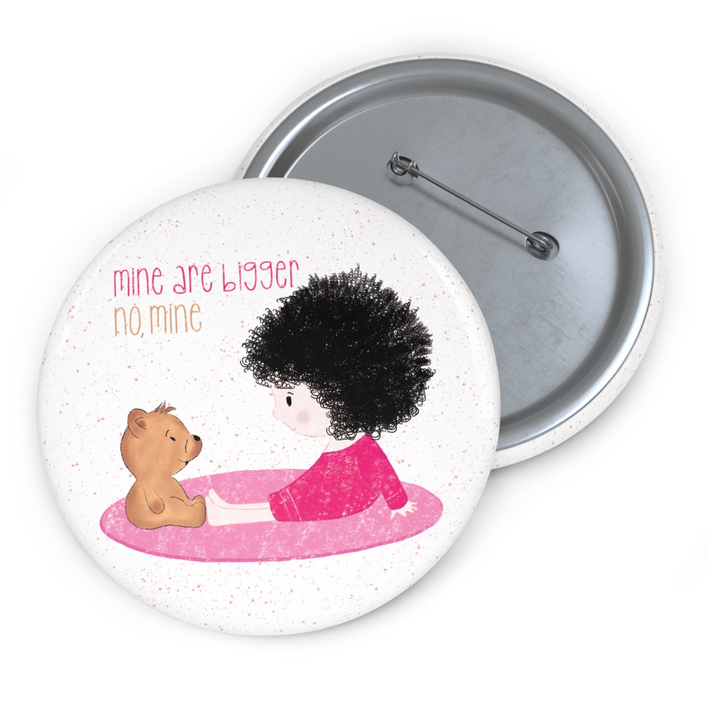 Playful nursery pin button featuring a cartoon child and a stuffed bear sitting on a pink mat, with the text 'mine are bigger,  no, mine’, size 2.25”, kidlic