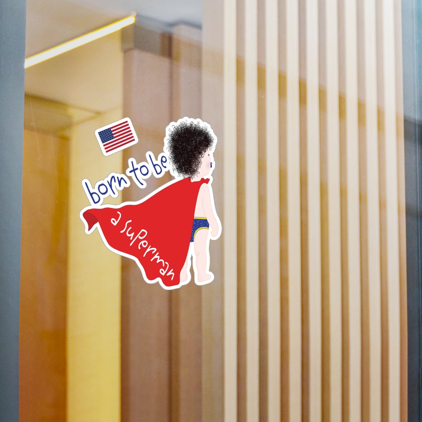 Funny baby Superman wall decal applied to a glass surface