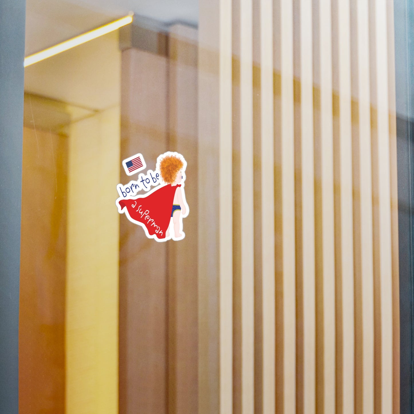 Redhead Superman baby wall decal displayed on a glass wall in a modern nursery space